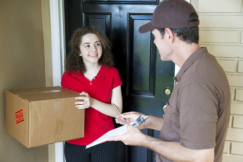 Delivery man giving a package to a customer
