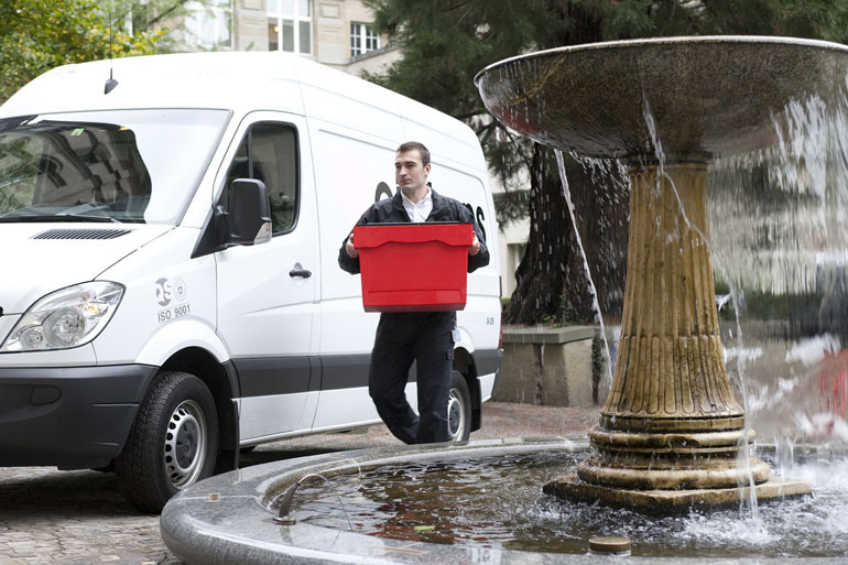 Courier Van and Driver Carrying a Red Box
