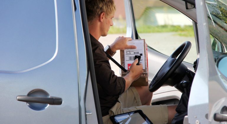 Courier Driver inside a van scanning order delivery confirmation